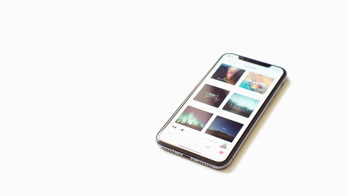 space gray iPhone X on white surface